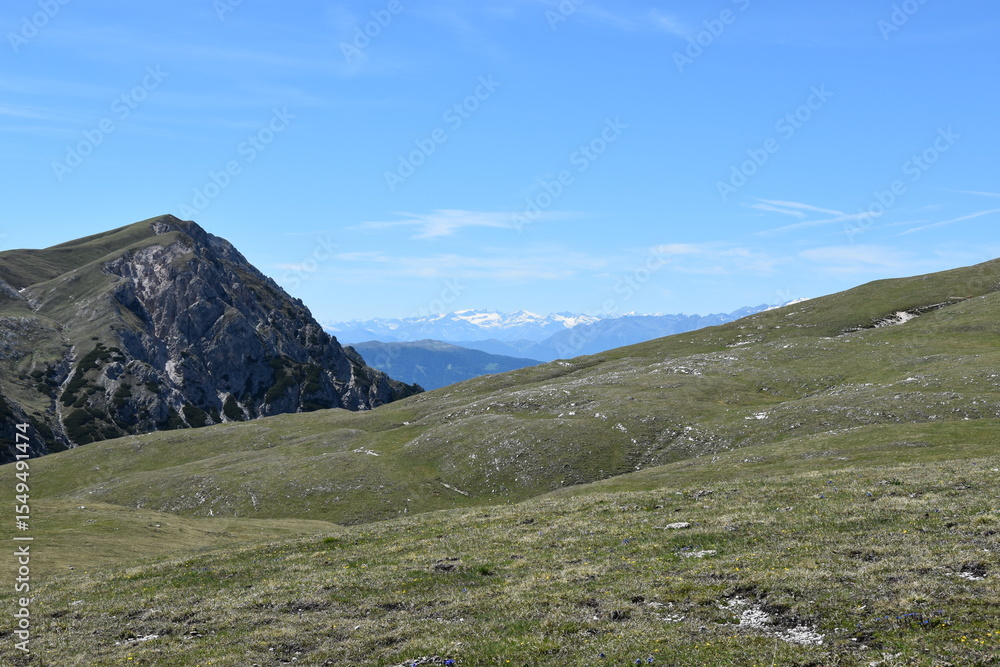 Serene Mountain Landscape with Clear Blue Sky and Lush Green Fields Serene Mountain Landscape with Clear Blue Sky and Lush Green Fields