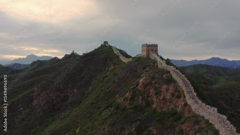 Breathtaking aerial perspective of Great Wall of China. Showcases rugged terrain, historic architecture, and vibrant sunset colors illuminating the landscape. Breathtaking aerial perspective of Great Wall of China. Showcases rugged terrain, historic architecture, and vibrant sunset colors illuminating the landscape.