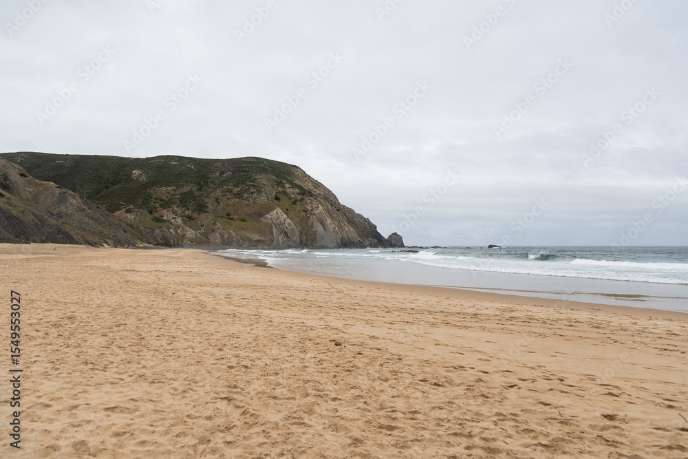 A Serene Stretch of Portuguese Beach Beckons with Its Soft Sands and Rolling Waves A Serene Stretch of Portuguese Beach Beckons with Its Soft Sands and Rolling Waves