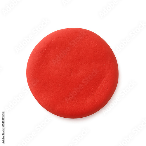 A single, round disc of vibrant red modeling clay, isolated on a white background.