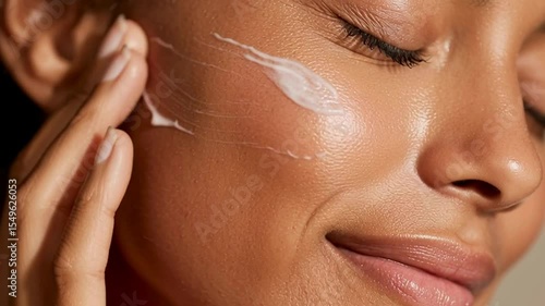 Close-up of Woman Applying Cream on Face for Healthy Skin Glow