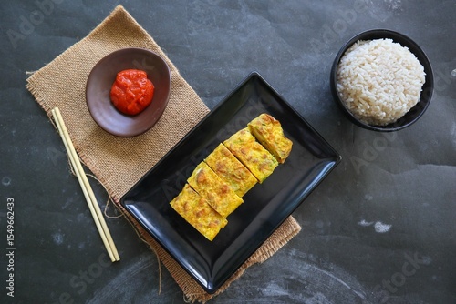 Telur dadar gulung or Tamagoyaki or Japaneses egg roll. Gyeran Mari or Korean Rolled Omelette. fried egg