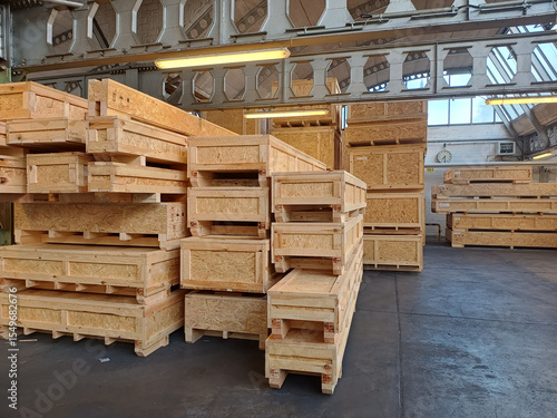 Industrial wooden crates stacked in warehouse ready for packaging and shipping.
