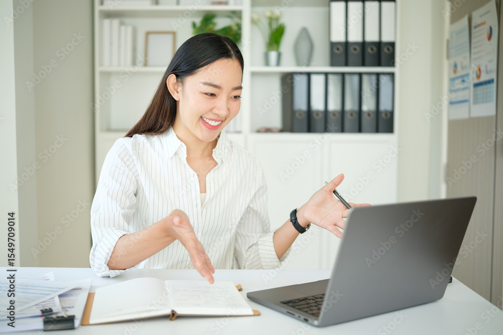 Smiling businesswoman having an online meeting via laptop, gesturing while explaining ideas. Smiling businesswoman having an online meeting via laptop, gesturing while explaining ideas.