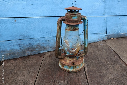 antique petromak lamp (teplok) which still uses kerosene fuel on wood background