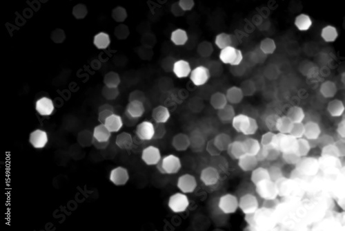 White gray blurred bokeh lights on black background