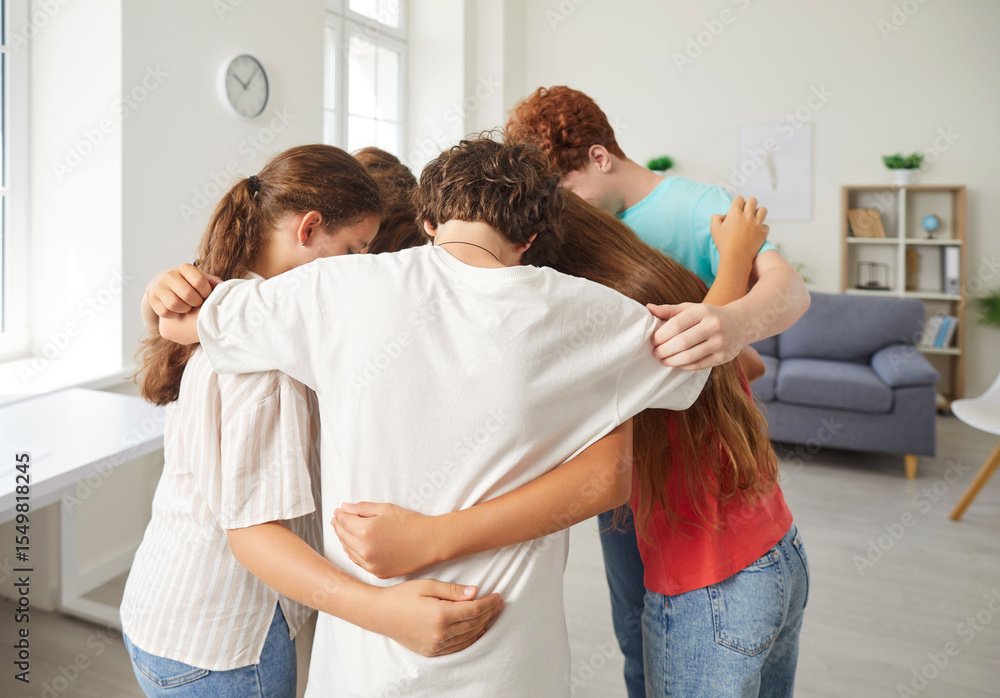 Fototapeta premium School children group in common hug, pre-teens, teenagers diverse friends embrace greeting in expression of love, care, support, welcome or recognition, enjoy education community club, positive unity