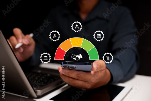 A person uses a smartphone with a credit score gauge and finance icons, indicating digital financial management and credit monitoring.