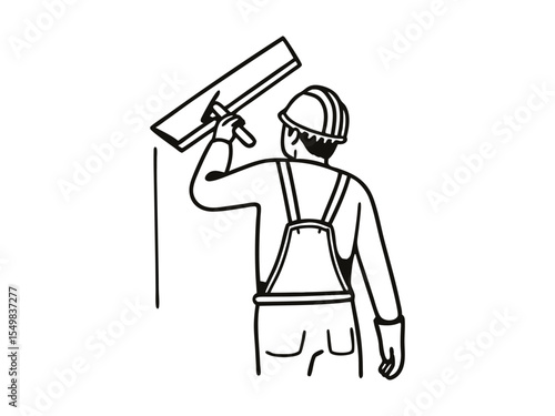 A man working in uniform plastering the wall indoors