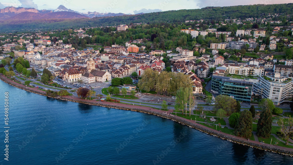 Obraz premium A panoramic aerial view around the old town of the city Evian-les-Bains in France on a sunny spring afternoon
