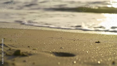 Wallpaper Mural Tropical beach landscape with footprints in the sand near the ocean waves under a summer sky Torontodigital.ca