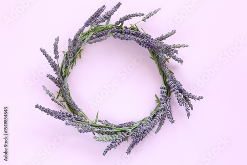 Lavender wreath decoration on pastel pink background with copy space