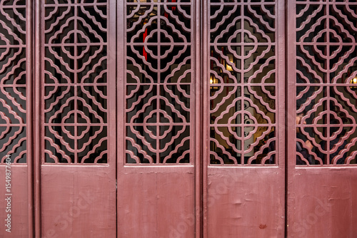 Traditional Chinese red brown door with lattice. Heritage building or temple architecture