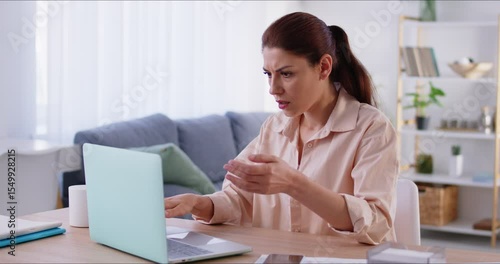 Young upset frustrated woman sitting at desk on workplace at home or in office worried about laptop crash or forgetting password. Female employee losing job result on broken pc. 4k video.