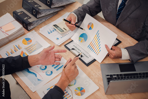 Business team discuss and explain marketing plan to plan financial strategy for business owner using laptop, calculator, chart sheet to calculate and summarize results. Business and finance concept.