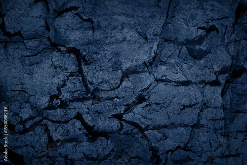 Texture of blue tree bark, trunk, coal, stone background. Dark wallpaper with rough cracked texture. Empty grunge wall concept, floor backdrop. Abstract surface mockup. Top view, close up, copy space