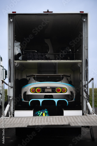 Race Car Loaded in Transport Trailer – Rear View of Performance Vehicle in Motorsport Hauler