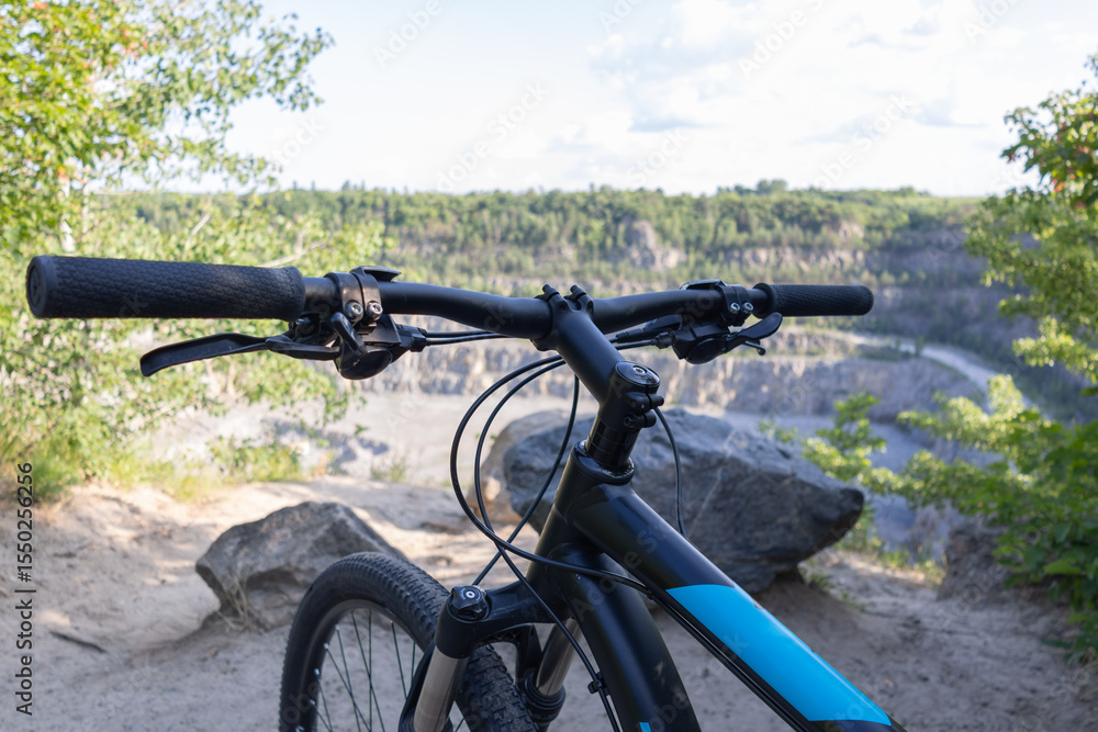 Fototapeta premium Mountain Bike Handlebar View on Scenic Quarry Landscape