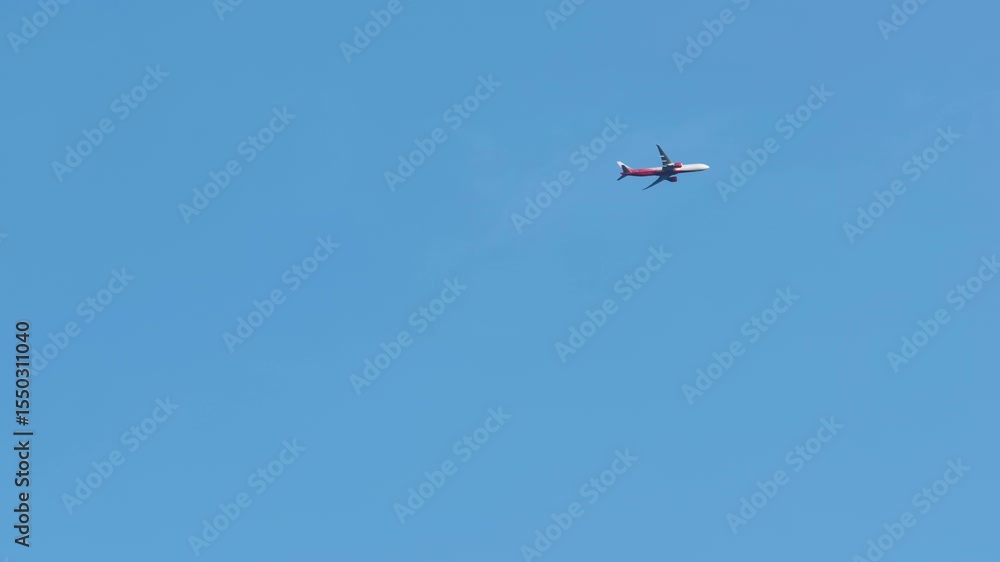 An airplane takes off against a blue sky. An airplane takes off against a blue sky.