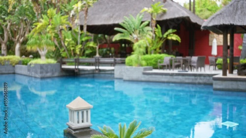 Wallpaper Mural Blurred tropical resort scene with luxurious pool and lush greenery enhancing the outdoor hotel ambiance in a defocused composition. Torontodigital.ca