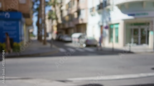 Wallpaper Mural Blurry outdoor street scene with defocused background including man and woman walking among buildings and cars in urban area on sunny day Torontodigital.ca