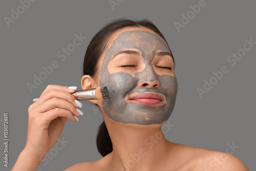 Young woman applying clay m...