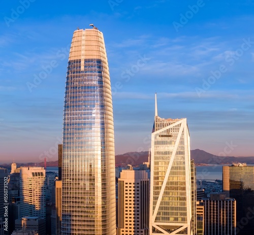 San Francisco, USA: A high-angle view of the city skyline at sunset, showcasing the Salesforce Tower and the Transamerica Pyramid. The photo captures the city's architecture.
