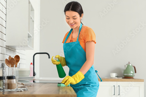 Young woman with spray and ...
