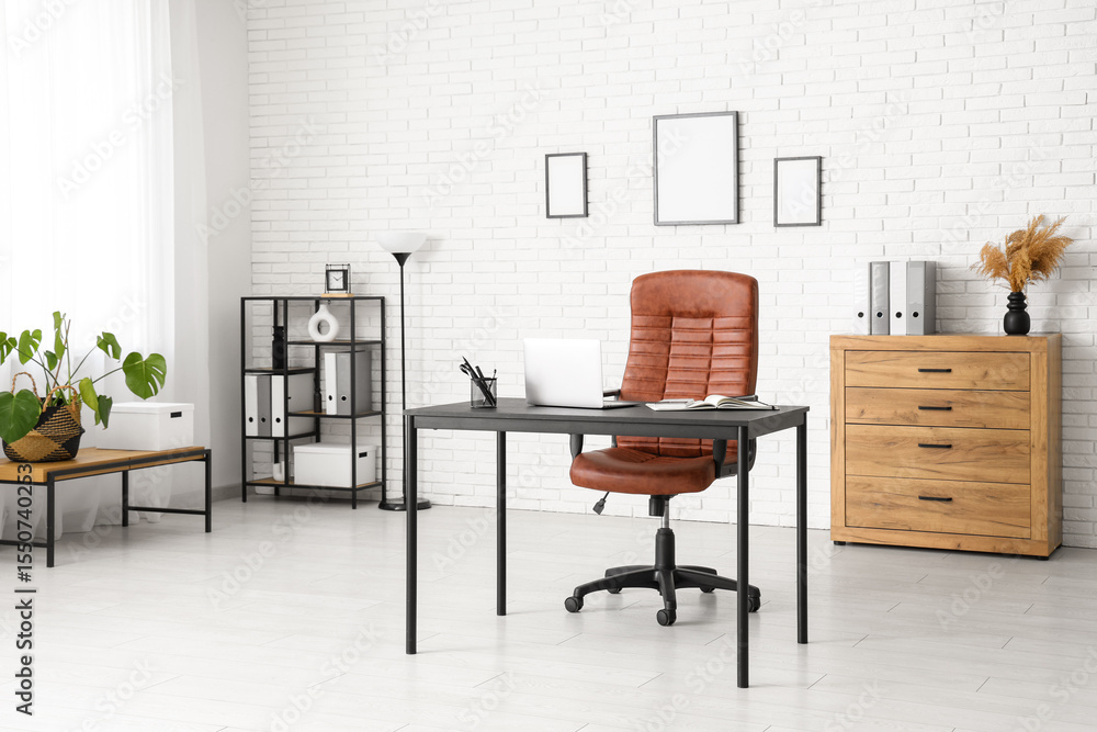 Fototapeta premium Interior of modern office with workplace, lamp and shelf unit