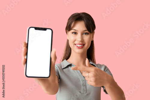 Smiling young woman holding...