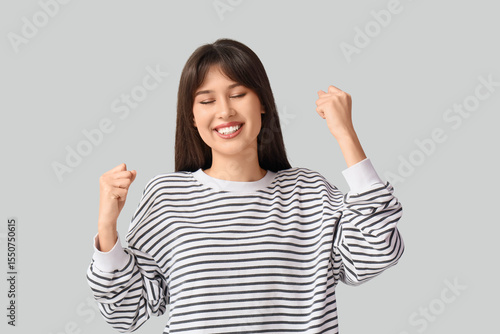 Smiling young woman on ligh...