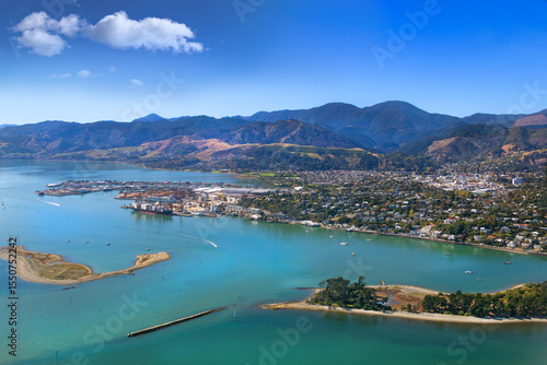 Nelson, New Zealand. Aerial view of harbour, city, suburbs, port, hills, with 'The Cut', entrance to Nelson Haven from Tasman Bay between the Boulder Bank and Haulashore Island.