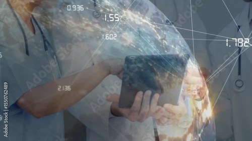 Medical team tapping tablet screen and correlating global stats with rotating globe sharing insight