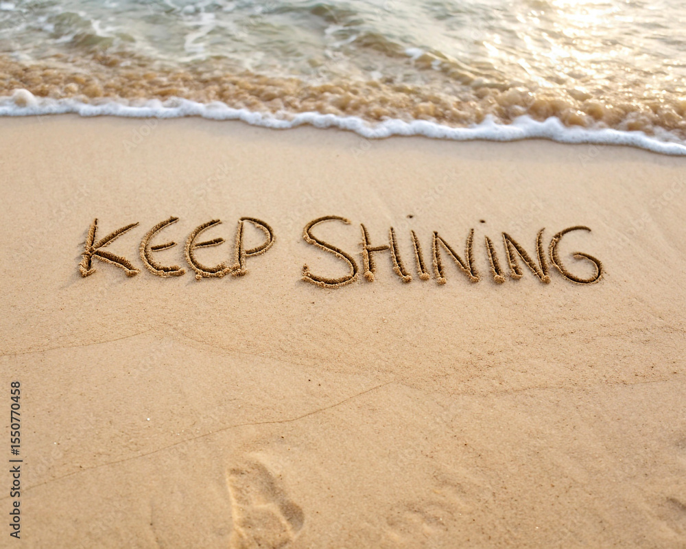 Fototapeta premium Keep shining message written in the sand on a beach with gentle waves approaching