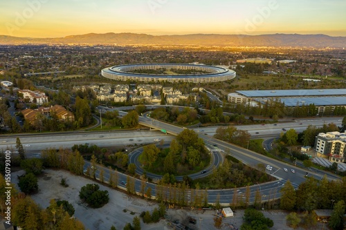 Aerial view of Apple Park headquarters in Cupertino, California, USA. The circular building is a landmark of Silicon Valley and a hub for technology innovation.