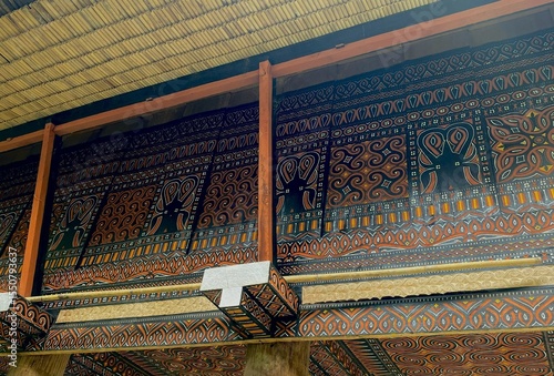 Colorful Torajan ethnic designs and patterns on traditional tongkonan houses in Toraja, South Sulawesi.