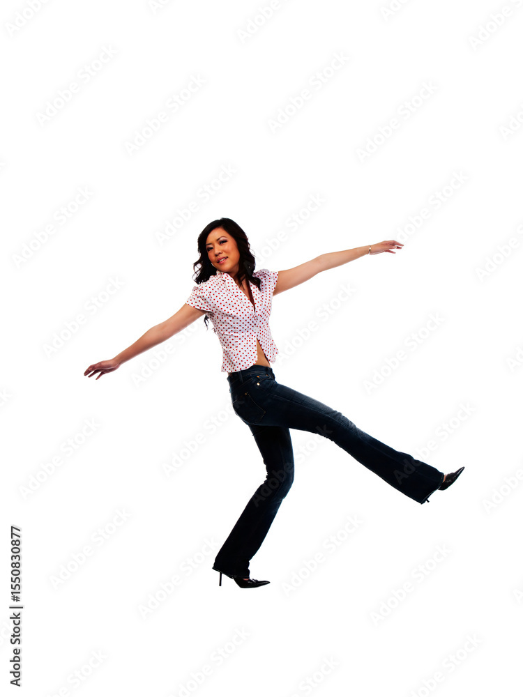Obraz premium Young Asian American Woman In Jeans Kicking Up Leg
