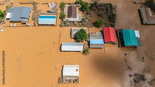Fototapeta Naklejka Na Ścianę i Meble -  Aerial view of small village in suburb of Chiang Rai flooding by Kok river after typhoon Yagi has swept Southeast Asia. The storm is Asia's most powerful this year (2024).