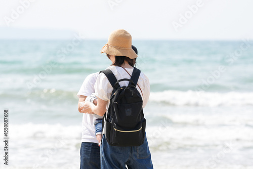 Photography In early March, a 1-year-old Japanese girl explores the beach with curiosity while her parents in their 30s watch her closely