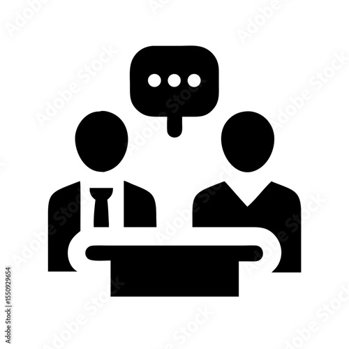 Black icon of two individuals at a table with a speech bubble, symbolizing an interview, discussion, or professional conversation.
