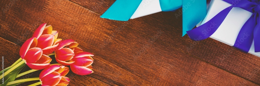 Fototapeta premium Flowers on wood floor with gifts