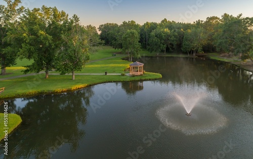 Canvas Print Aerial view of Fairview Park, Dublin, Georgia, USA, featuring a gazebo on a peninsula, a fountain in the lake, and lush green trees