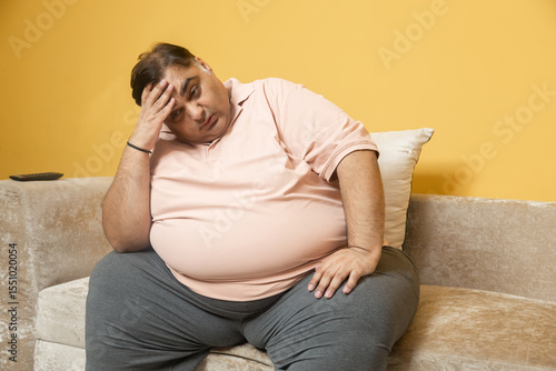 Bild auf Leinwand Stressed overweight indian man suffer with excess belly fat
