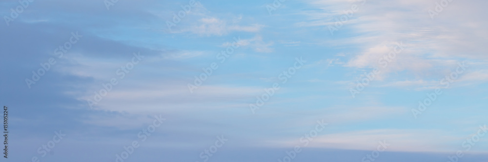 Obraz premium Blue sky background with clouds. Wide panoramic background for design.