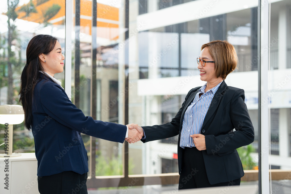 Happy asian businesswoman shake hand of asian lady client make deal with female customer at meeting with laptop, diverse women partnership, respect and collaboration concept. Happy asian businesswoman shake hand of asian lady client make deal with female customer at meeting with laptop, diverse women partnership, respect and collaboration concept.