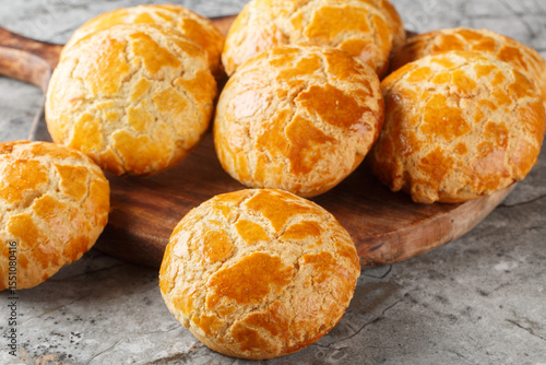 Chinese pineapple buns or bo lo bao they don’t actually contain any pineapple, but get their names from their golden crusted tops closeup on the table. Horizontal