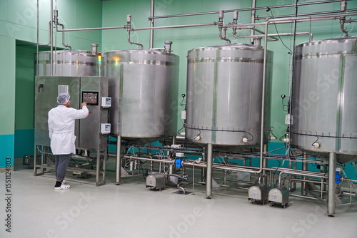 Almaty, Kazakhstan - 05.15.2025 : An employee checks the tanks for the production of liquid cosmetics.