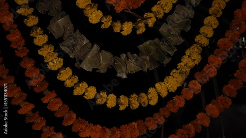 Beautiful marigold flower garland with green mango leaves hangs as a traditional decorative border in the background, symbolizing Indian culture, religion, and festive celebrations like Diwali, Pongal