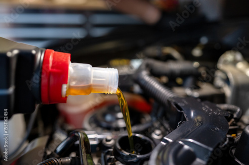 Φωτογραφία Close-up of engine oil being poured into a modern car engine during a maintenance procedure