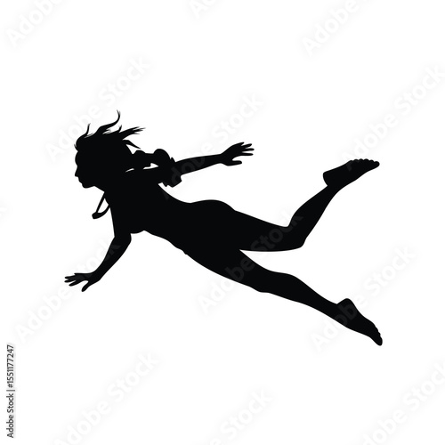 Silhouette of a female diver swimming gracefully through the clear water